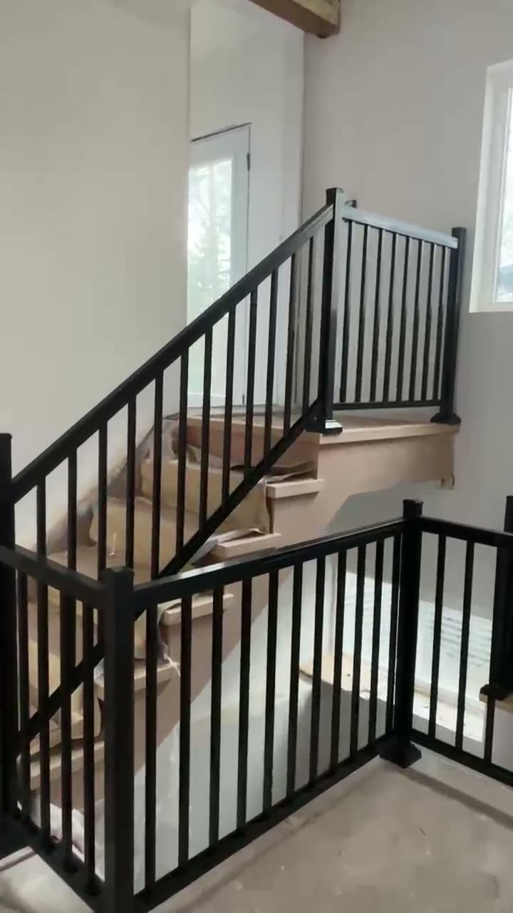Stair railing with glass infill panels along the landing